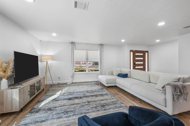 living room with dark hardwood / wood-style flooring