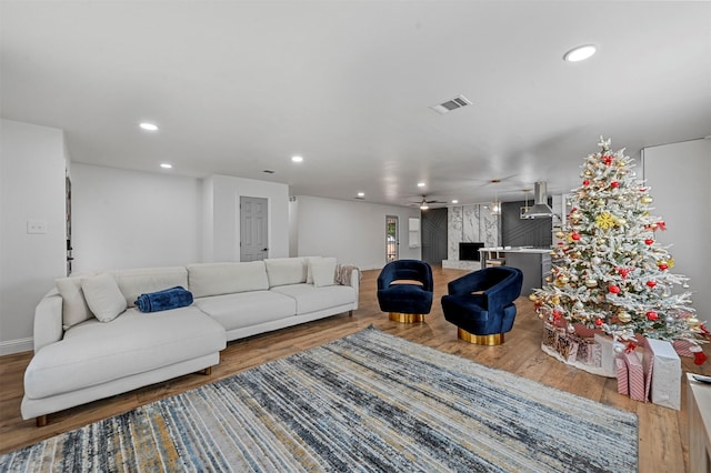 living room with hardwood / wood-style flooring and ceiling fan