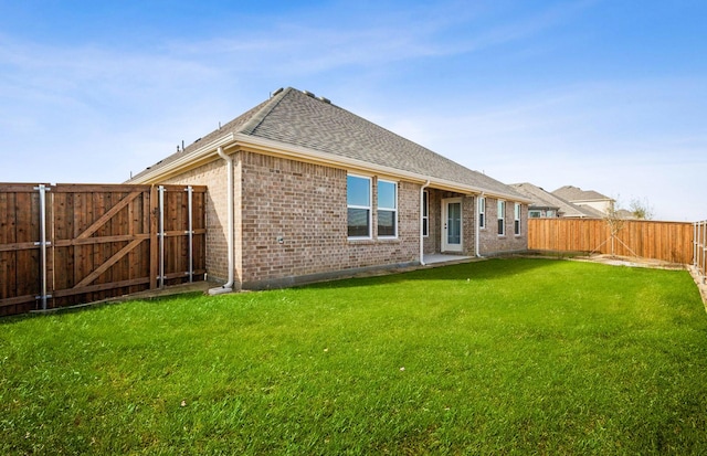 back of house featuring a lawn