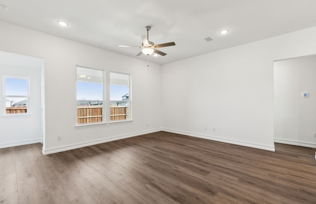 spare room with dark wood-type flooring and ceiling fan