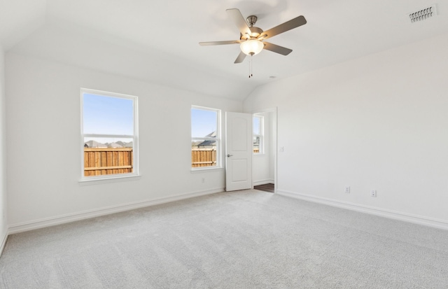 carpeted empty room featuring ceiling fan and vaulted ceiling