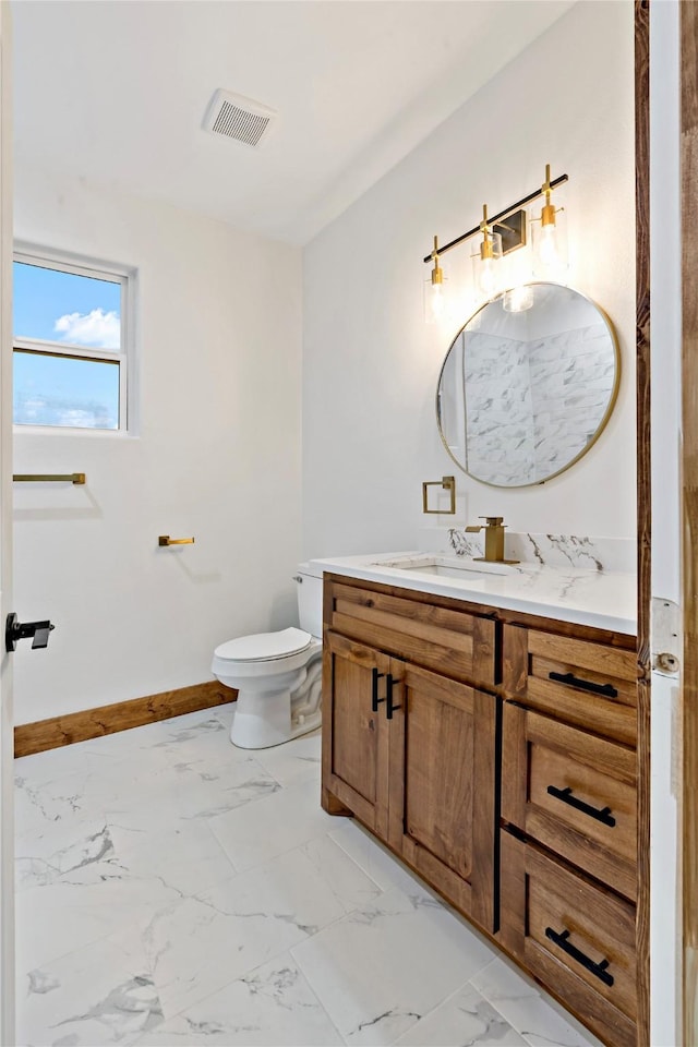 bathroom featuring vanity and toilet