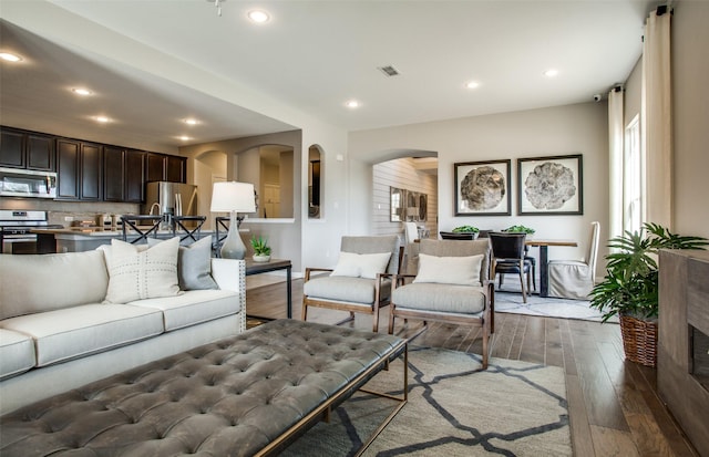 living room with dark hardwood / wood-style flooring