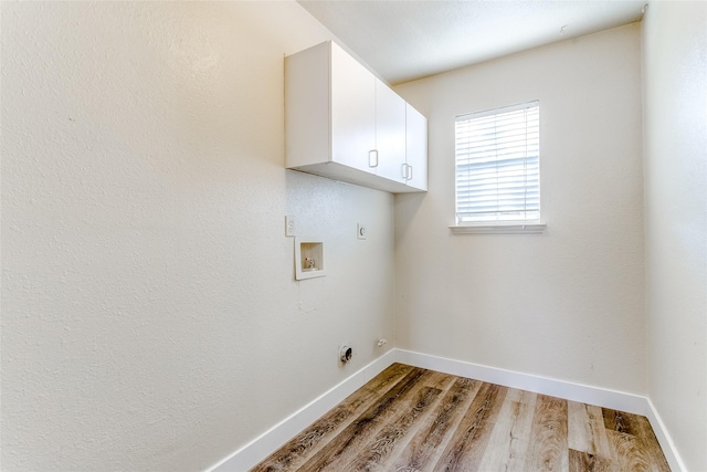 laundry room featuring cabinets, washer hookup, light hardwood / wood-style floors, and hookup for an electric dryer