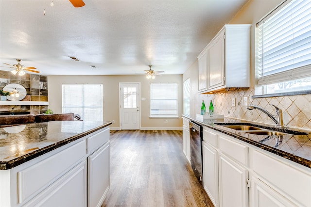 kitchen with tasteful backsplash, a textured ceiling, sink, light hardwood / wood-style flooring, and white cabinetry