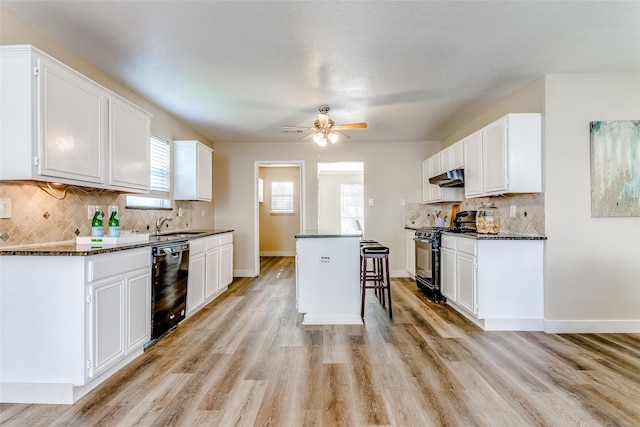 kitchen with white cabinetry, a center island, and black appliances