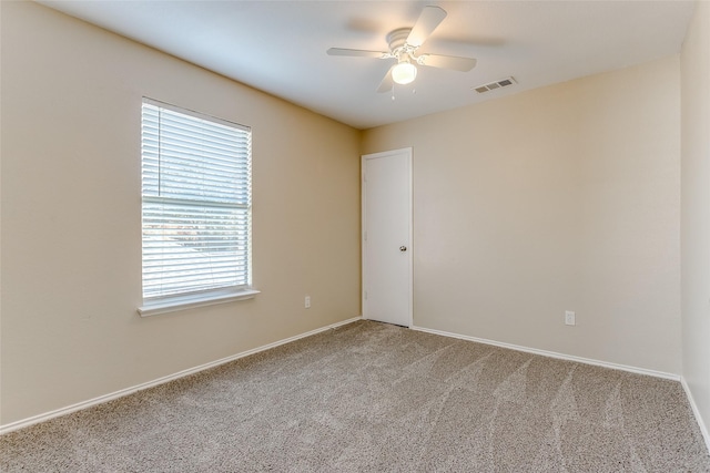 spare room with ceiling fan and carpet floors