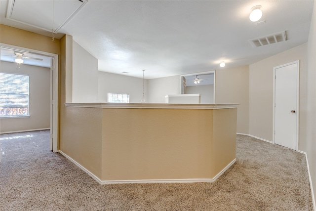 kitchen featuring ceiling fan and light carpet