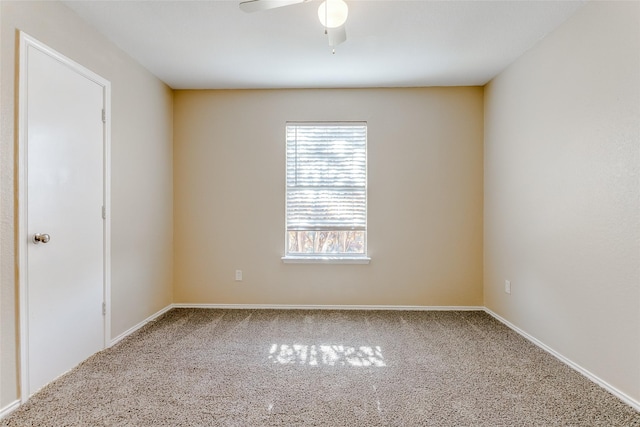 unfurnished room with ceiling fan and carpet