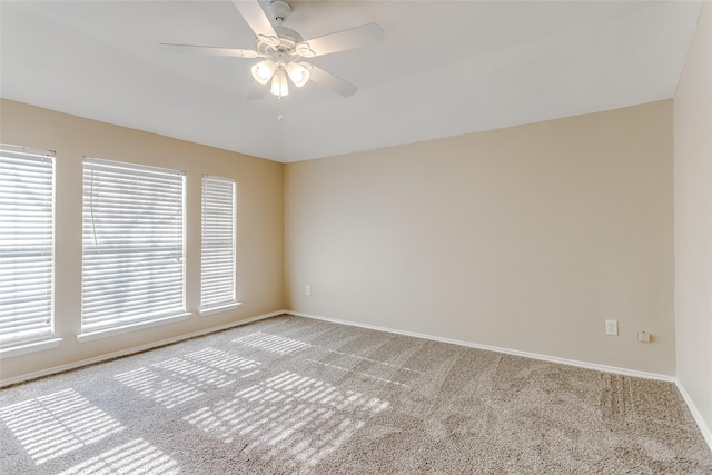 carpeted spare room with ceiling fan