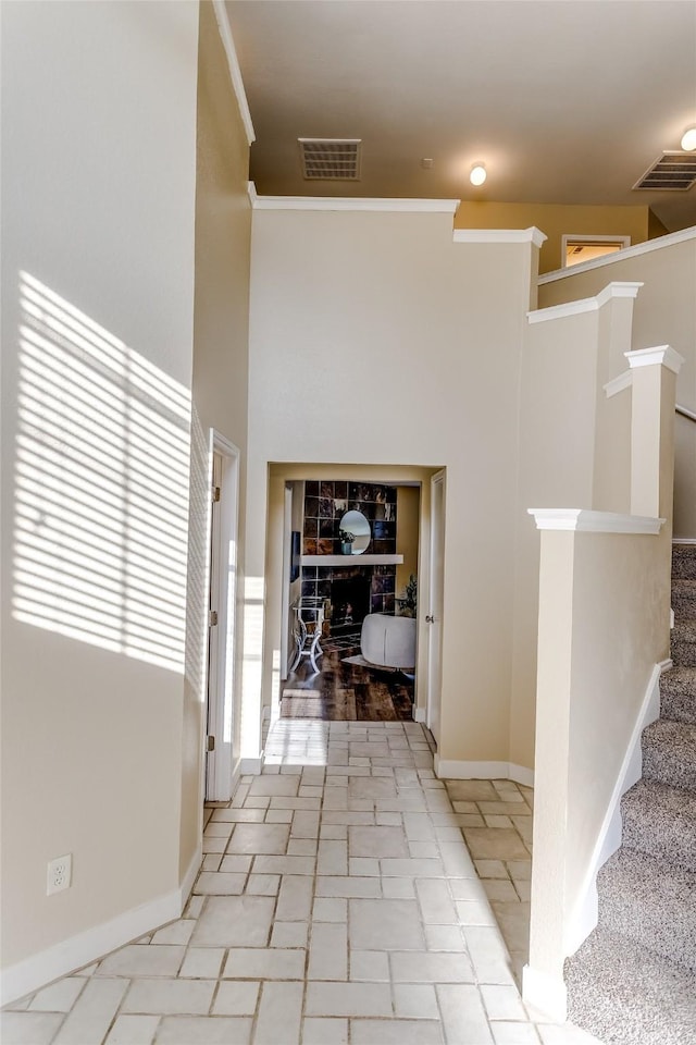 hallway featuring a high ceiling and ornamental molding