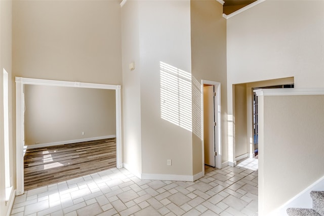 interior space featuring light hardwood / wood-style flooring and a high ceiling