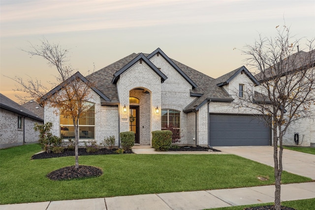 french country style house featuring a lawn