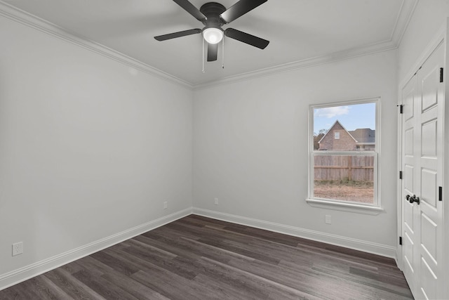 empty room with crown molding, dark hardwood / wood-style floors, and ceiling fan