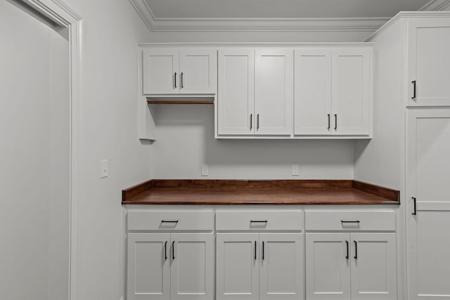 kitchen featuring crown molding and white cabinets