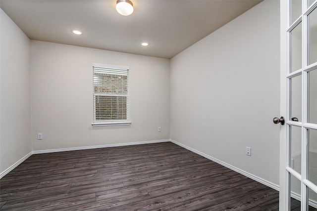 spare room with dark hardwood / wood-style floors