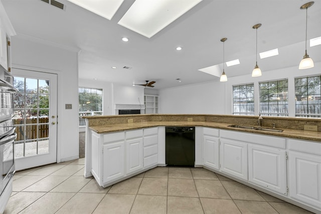 kitchen with white cabinetry, hanging light fixtures, sink, and dishwasher