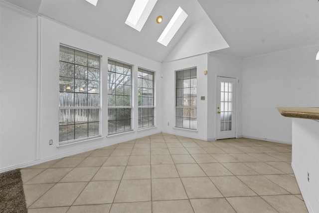 unfurnished room featuring light tile patterned flooring, high vaulted ceiling, and a skylight