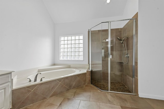 bathroom featuring vanity, vaulted ceiling, and independent shower and bath