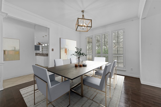 dining space featuring dark hardwood / wood-style flooring, crown molding, and a notable chandelier