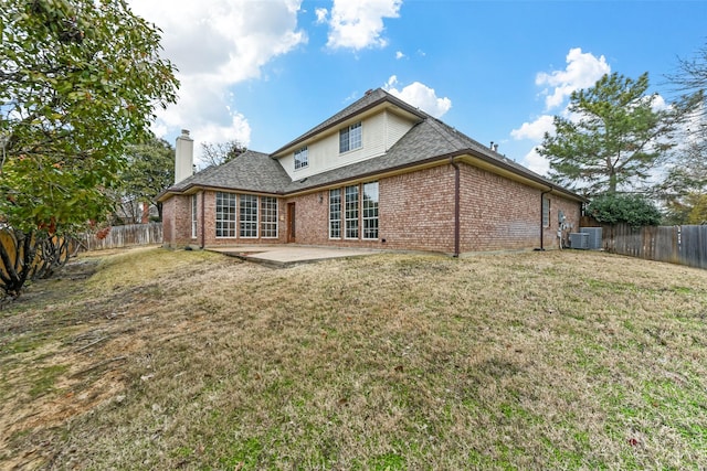 back of property with a patio, central AC unit, and a lawn