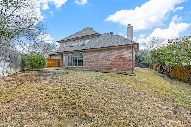 back of house with a yard