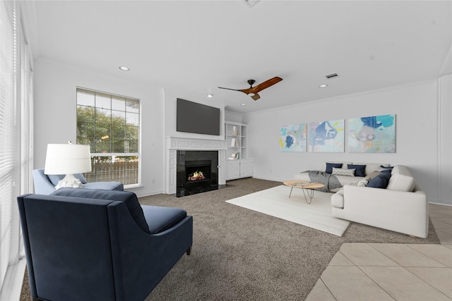 tiled living room featuring crown molding and ceiling fan