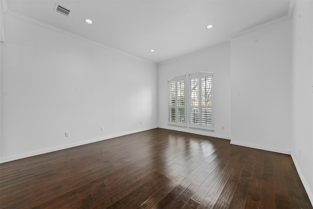 empty room featuring ornamental molding and dark hardwood / wood-style flooring