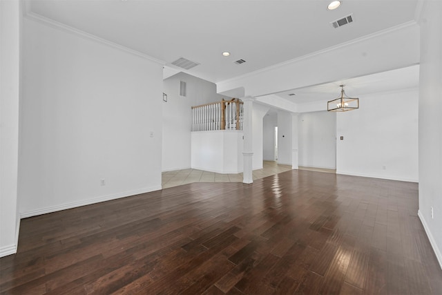 unfurnished living room featuring hardwood / wood-style floors, ornamental molding, and a chandelier