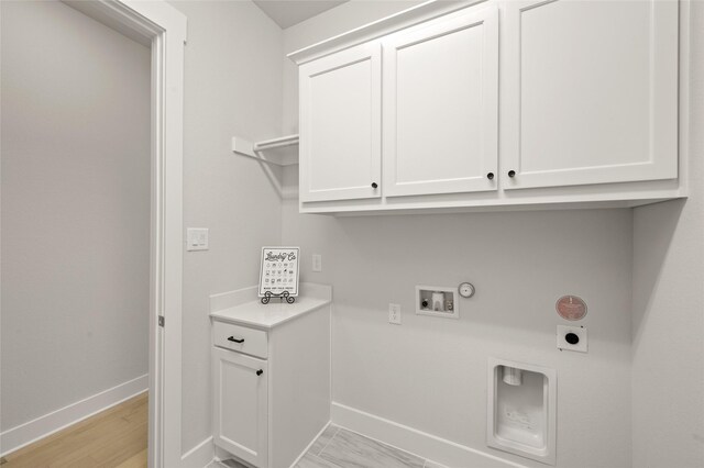 washroom with gas dryer hookup, washer hookup, baseboards, electric dryer hookup, and cabinet space