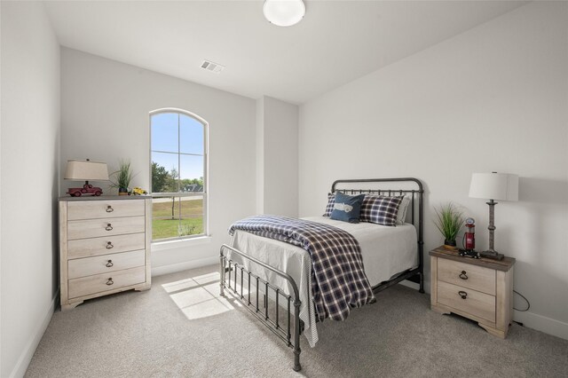 bedroom featuring light carpet, baseboards, and visible vents