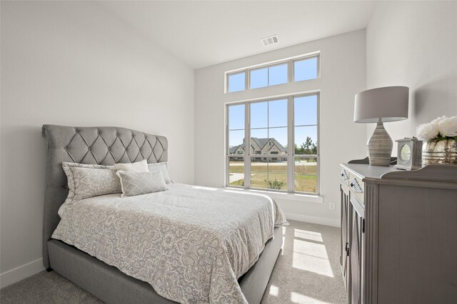 bedroom with baseboards, carpet floors, and visible vents