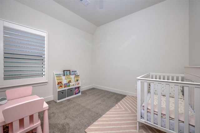 bedroom featuring a nursery area and carpet