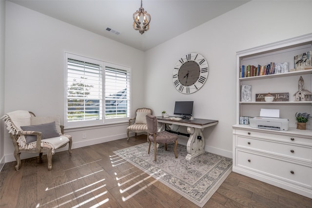 home office featuring an inviting chandelier and dark wood-type flooring