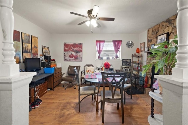 dining space with hardwood / wood-style flooring and ceiling fan