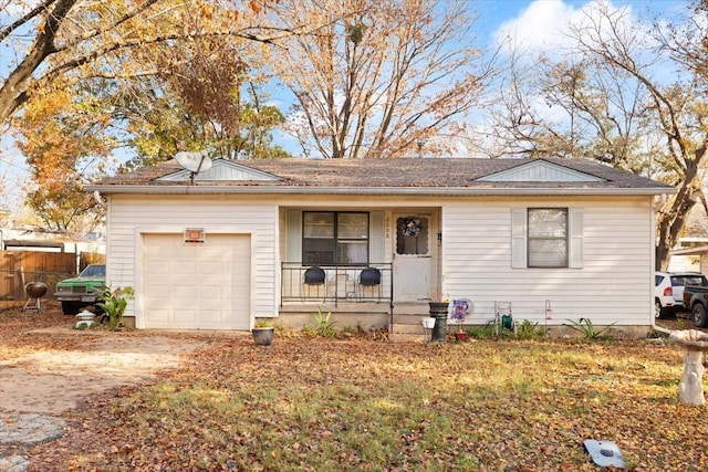 single story home with covered porch and a garage