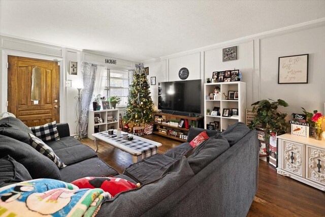 living room featuring dark hardwood / wood-style floors and crown molding