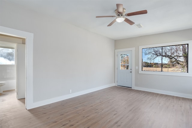 empty room featuring ceiling fan and light wood-type flooring