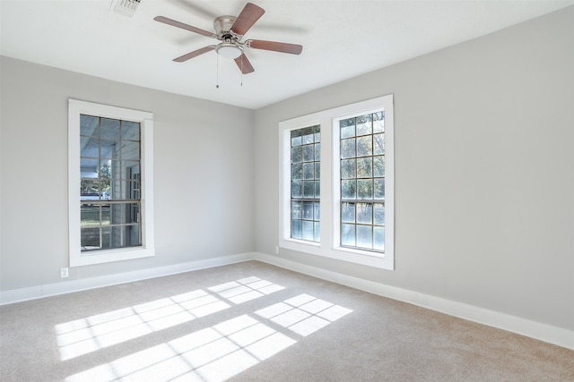 carpeted empty room featuring ceiling fan