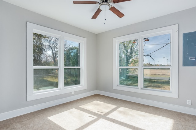 carpeted spare room featuring ceiling fan and electric panel