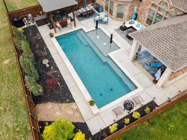 pool with a patio, a fenced backyard, an outdoor structure, an outdoor living space, and a gazebo