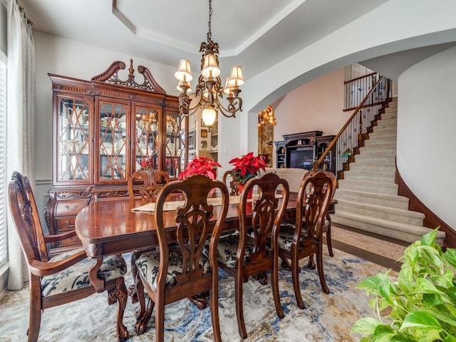 dining room featuring a tray ceiling and a chandelier