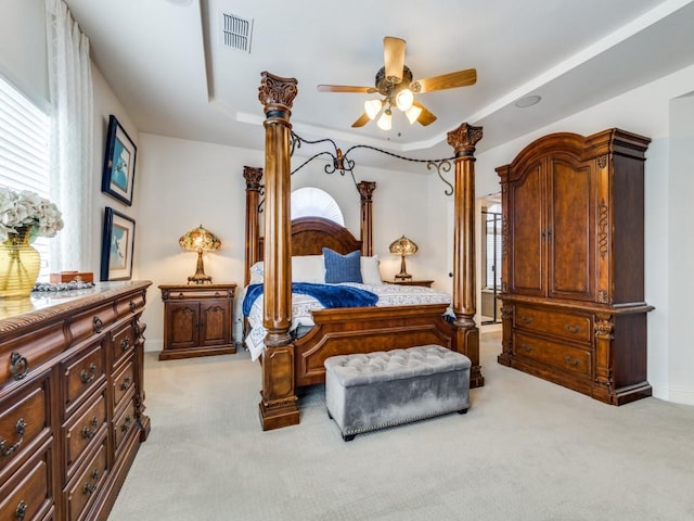 carpeted bedroom featuring a raised ceiling and ceiling fan