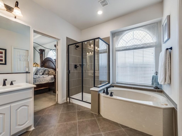 bathroom featuring tile patterned flooring, vanity, and plus walk in shower