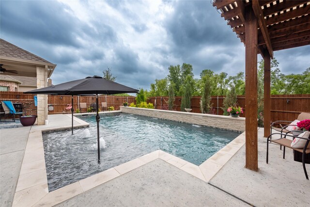 view of swimming pool featuring a patio, pool water feature, and ceiling fan