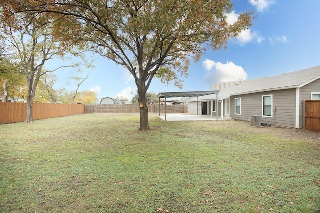 view of yard with central AC and a patio area