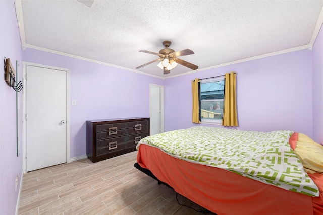 bedroom featuring a textured ceiling, light hardwood / wood-style flooring, ceiling fan, and ornamental molding