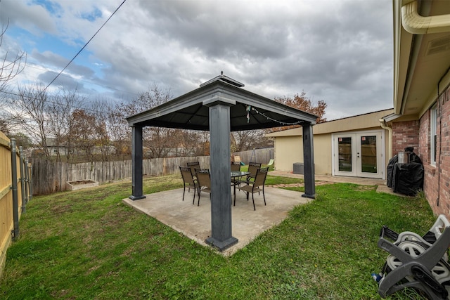 view of yard with a gazebo and french doors