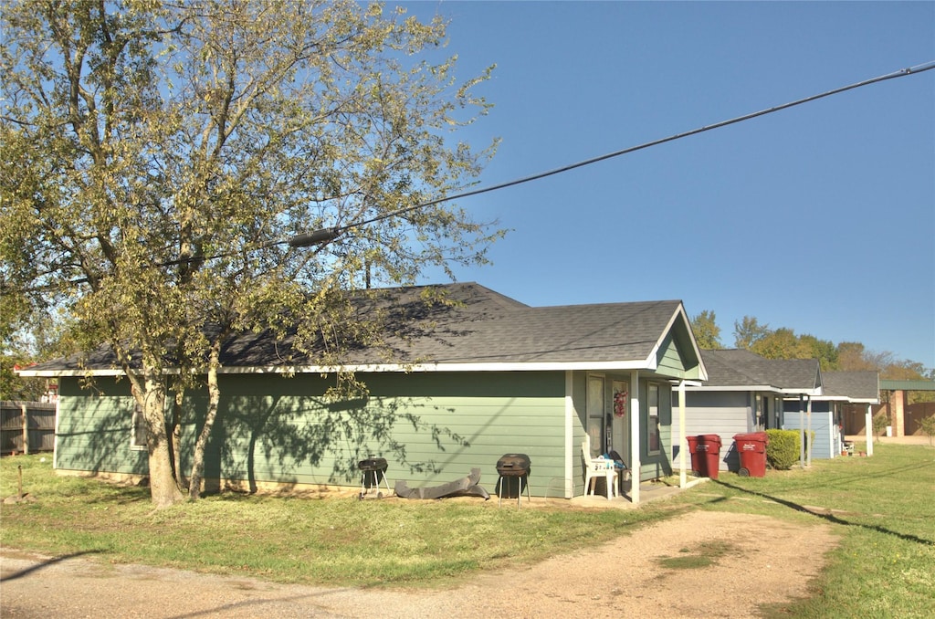 view of side of property with a lawn