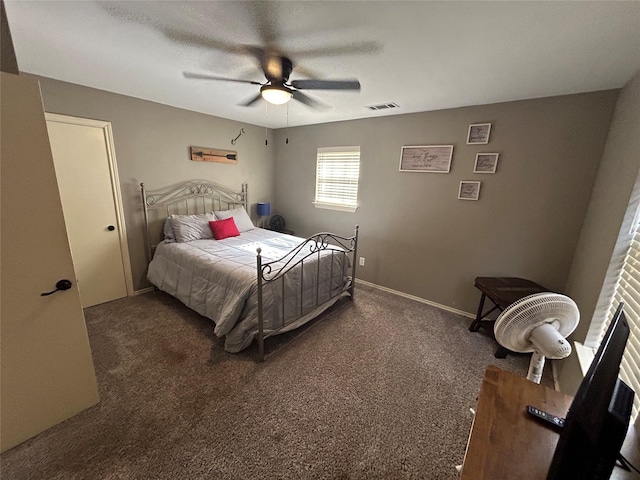 bedroom featuring ceiling fan and dark carpet